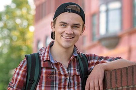 Young man with a backward facing baseball cap